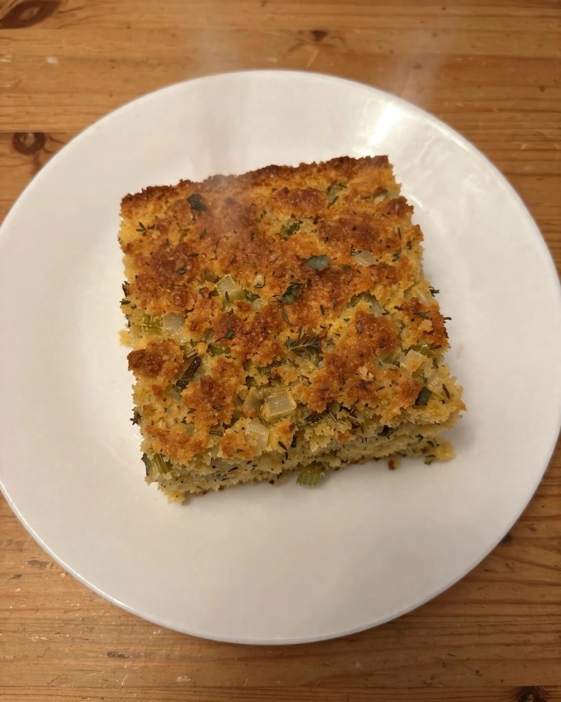 A serving of cornbread dressing on a white plate