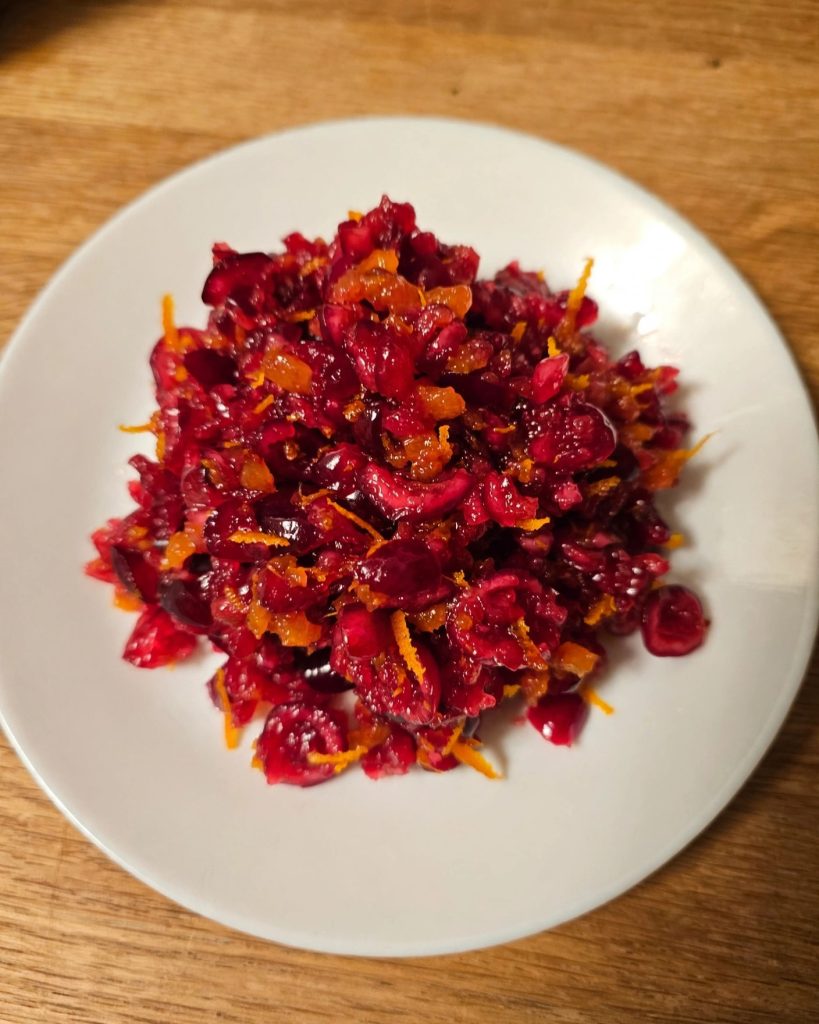 A serving of cranberry orange relish on a small white plate