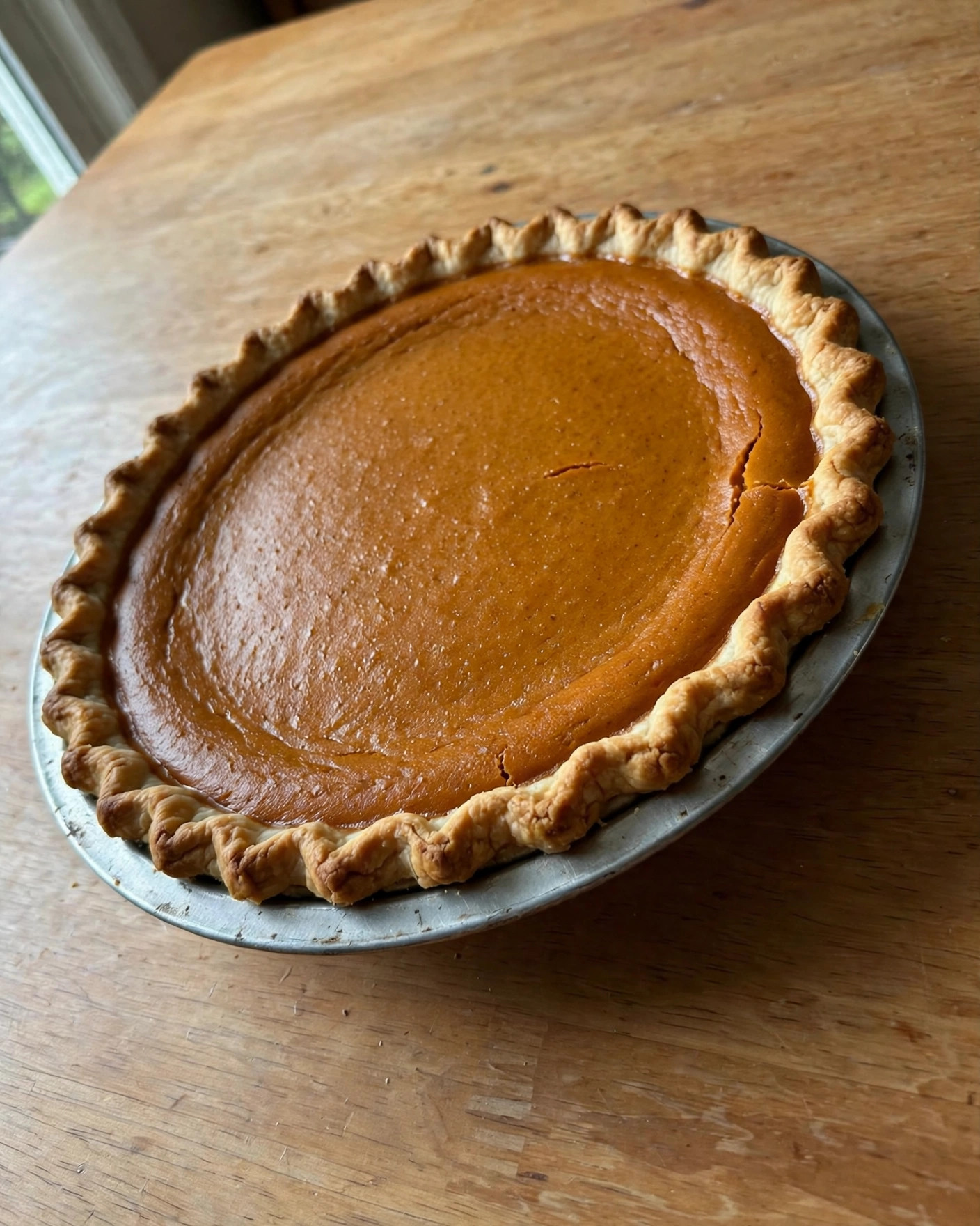 Classic pumpkin pie with a smooth spiced filling in a pie plate